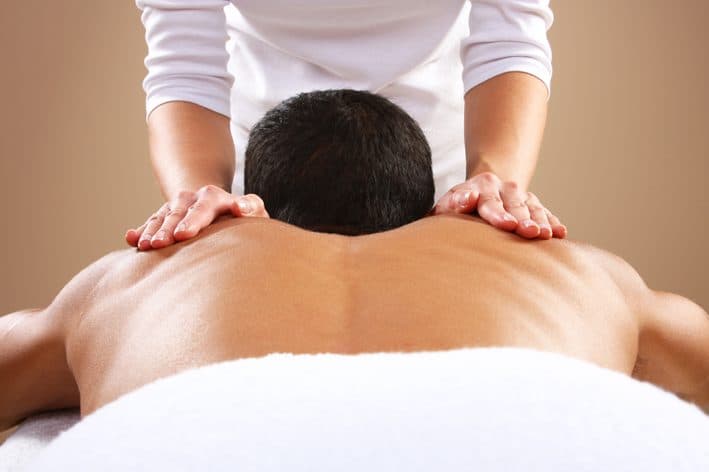 Massage therapy session — gentle hands-on shoulder work at Vibrant Life Centre