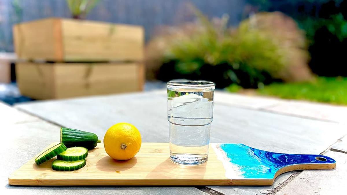Glass of water with slices of lemon and cucumber